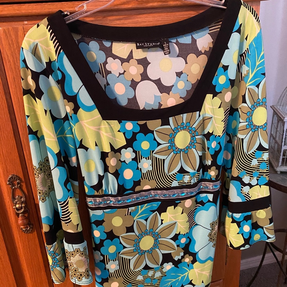 Super fun top with blue jewel embellishment.